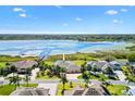 Waterfront property featuring a home with lush landscaping and private boat dock at 2332 Clearwater Run, The Villages, FL 32162