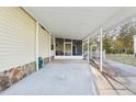 A spacious covered carport with a concrete floor provides shelter with an adjacent screened porch at 2557 Karen Dr, Mount Dora, FL 32757