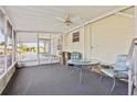 Cozy screened-in porch with neutral carpet, ceiling fan, and space for outdoor seating at 2557 Karen Dr, Mount Dora, FL 32757