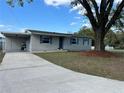 Cozy single-story home featuring a covered carport and a large tree in the front yard at 2803 Joleen Dr, Eustis, FL 32726