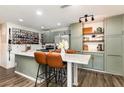 Charming kitchen featuring sage cabinetry, stainless steel appliances, and a marble countertop island at 2803 Joleen Dr, Eustis, FL 32726