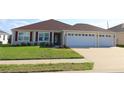 Inviting single-story home with a neatly maintained lawn, offering a comfortable and welcoming street presence at 3290 Sennett Cir, Oxford, FL 34484