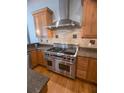 Close up of the kitchen showing stainless steel range, granite countertops, and custom cabinetry at 42316 E Saffron Ct, Eustis, FL 32736