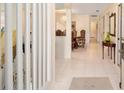 Bright foyer with tile flooring, white staircase, and view of the dining area at 480 Ne 45Th Ter, Ocala, FL 34470