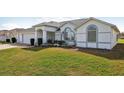 Well-maintained single-story home with lush green lawn and manicured landscaping at 5332 Nw 20Th Pl, Ocala, FL 34482