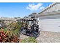 Charming single-story home featuring an attached two-car garage and a golf cart in the driveway at 565 Brighton Dr, The Villages, FL 32162