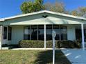 Charming single-story home featuring a large front window and well-manicured landscaping in the front yard at 607 Webb Way, The Villages, FL 32159