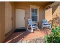 Cozy front porch with chairs, perfect for enjoying a morning coffee or evening relaxation at 906 Calabria Ave, Davenport, FL 33897