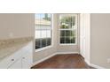 A spacious dining room featuring wood floors and bright windows with natural light at 9481 Sw 93Rd Loop, Ocala, FL 34481