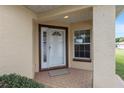 A welcoming front door with brick flooring and a protective porch at 9481 Sw 93Rd Loop, Ocala, FL 34481