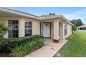 Inviting front entrance showcasing a well-lit walkway and meticulously maintained landscaping at 9481 Sw 93Rd Loop, Ocala, FL 34481