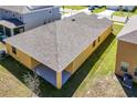 Aerial view of the backyard and covered patio, showcasing the home's layout and landscaping at 1041 Bradford Ridge Dr, Leesburg, FL 34748