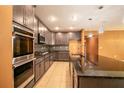 Modern kitchen with stainless steel appliances, granite countertops, and ample cabinet space at 1041 Bradford Ridge Dr, Leesburg, FL 34748