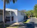 Well-maintained single-story home showcasing its clean white exterior and pleasant landscaping at 1135 Rue De Dore, Tavares, FL 32778