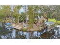 Waterfront property with multiple docks, scenic views, and a boat, providing easy access to water activities at 11415 Palmetto Dr, Tavares, FL 32778