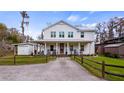 Charming two-story home with a covered front porch, fenced yard and gravel driveway at 12117 Cypress Ln, Clermont, FL 34711