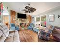 Inviting living room with a stone fireplace, wood accents, and comfortable seating at 132 E Belt Ave, Bushnell, FL 33513