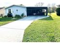 Charming single-story home featuring a well-maintained lawn and covered carport at 1336 E Schwartz Blvd, The Villages, FL 32159