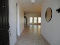 Inviting foyer with tile flooring and an open view to the living area at 1408 Diamond Loop Dr, Kissimmee, FL 34744