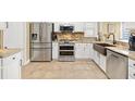 Stainless steel appliances complement the sleek cabinets and granite countertops in this eat-in kitchen at 17126 Se 78Th Larchmont Ct, The Villages, FL 32162