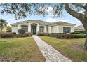 Beautiful home featuring a tiled roof, manicured landscaping, and a charming walkway to the front door at 2031 Capri Ln, Mount Dora, FL 32757