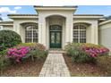 Charming home exterior with a well-maintained front yard and a decorative front door at 2031 Capri Ln, Mount Dora, FL 32757