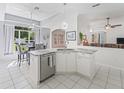 Bright and airy kitchen featuring a center island with sink and stainless steel dishwasher at 2039 Palo Alto Ave, The Villages, FL 32159