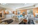 Inviting living room with white sofas, neutral walls, stylish decor, and connecting access to the kitchen at 26207 Avenida Las Colinas # 13A, Howey In The Hills, FL 34737