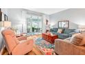 Spacious living room with hardwood floors, comfortable seating and sliding doors to a patio at 26821 Augusta Springs Cir, Leesburg, FL 34748
