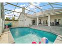 Relaxing screened-in pool with outdoor lounging area offers the perfect spot for summer fun at 288 Bent Oak Ct, Leesburg, FL 34748