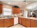 Bright kitchen featuring wood cabinetry, white appliances, and a large countertop space at 3076 Gulfport Ct, The Villages, FL 32163