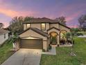 Charming two-story home with a well-maintained lawn and a welcoming front entrance at 3320 Callerton Rd, Clermont, FL 34714