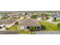 View of home with a well-kept lawn, screened lanai, and view of neighborhood at 3403 Rabbit Run Path, The Villages, FL 32163