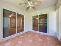 Covered patio with tile flooring and sliding glass doors leading to interior rooms at 3725 Westerham Dr, Clermont, FL 34711