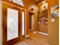 Elegant foyer features decorative glass door, wood flooring, and display shelving at 3733 Plantation Blvd, Leesburg, FL 34748