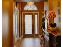 Inviting entryway showcasing decorative glass door, chandelier, and tiled flooring at 3733 Plantation Blvd, Leesburg, FL 34748