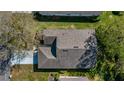 An aerial view reveals a well-maintained roof and mature trees surrounding the property at 3773 Eversholt St, Clermont, FL 34711