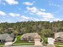 An aerial view of a charming house with mature trees and manicured landscaping at 5029 Greenbriar Trl, Mount Dora, FL 32757