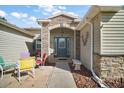 Inviting front entrance with a beautifully designed door and stone detailing with comfortable seating at 509 Grand Vista Trl, Leesburg, FL 34748