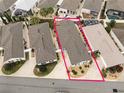 Aerial view of property and surrounding homes, highlighting property lines and neighborhood layout at 527 Richburg St, The Villages, FL 32162