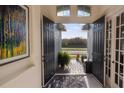 Inviting entryway featuring double doors, beautiful floors, and lots of natural light at 569 Bellflower Way, Clermont, FL 34715