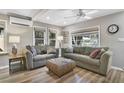 Bright living room featuring hardwood floors, neutral paint, two couches and lots of natural light at 630 E 8Th Ave, Mount Dora, FL 32757