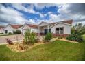 Lovely single-story home with a brick-paved driveway, tidy landscaping, and a welcoming front porch at 723 Palma Dr, Lady Lake, FL 32159