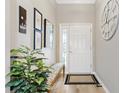 Welcoming entryway with bench, mirror, and decorative accents at 879 Pisano Way, The Villages, FL 32163