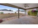 Covered patio overlooking a fenced backyard with minimal landscaping and a storage shed at 902 Chestnut Dr, Fruitland Park, FL 34731