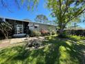 A well-maintained backyard with a screened-in porch and lush green lawn at 1004 Matthew Ave, Lady Lake, FL 32159