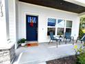 Inviting front porch with comfortable seating, a stylish door, and charming decor at 1013 Lake Elsie Dr, Tavares, FL 32778