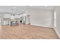 Open-concept living area showcasing the kitchen with white cabinets and stainless steel appliances at 13334 Sw 107 St, Dunnellon, FL 34432