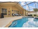 Inviting screened-in pool area with comfortable seating and clear blue water at 13753 Via Roma Cir, Clermont, FL 34711