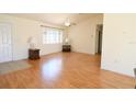 Inviting living room with wood floors, a ceiling fan, and lots of natural light from a window at 13828 Se 85Th Cir, Summerfield, FL 34491